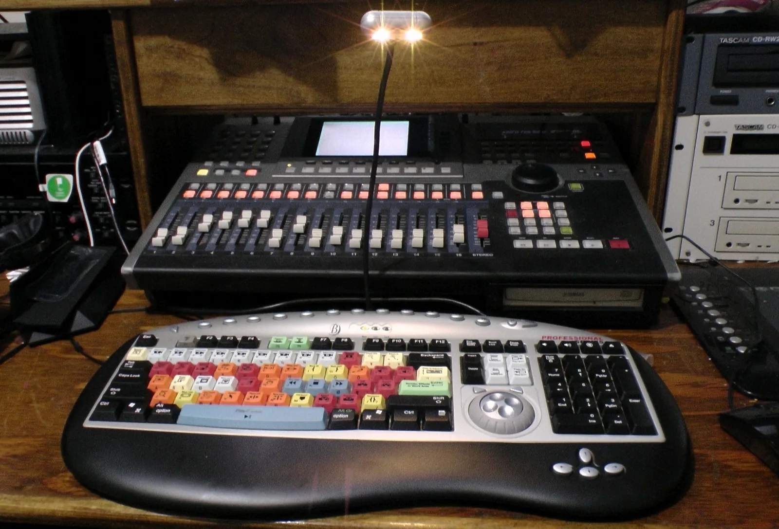 Color-coded keyboard and video control console on wooden desk