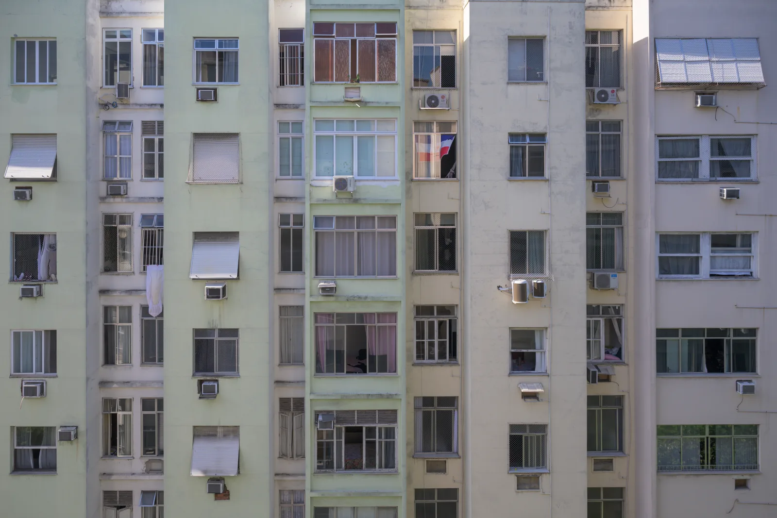 Apartment facade with repeated windows and air-conditioning units