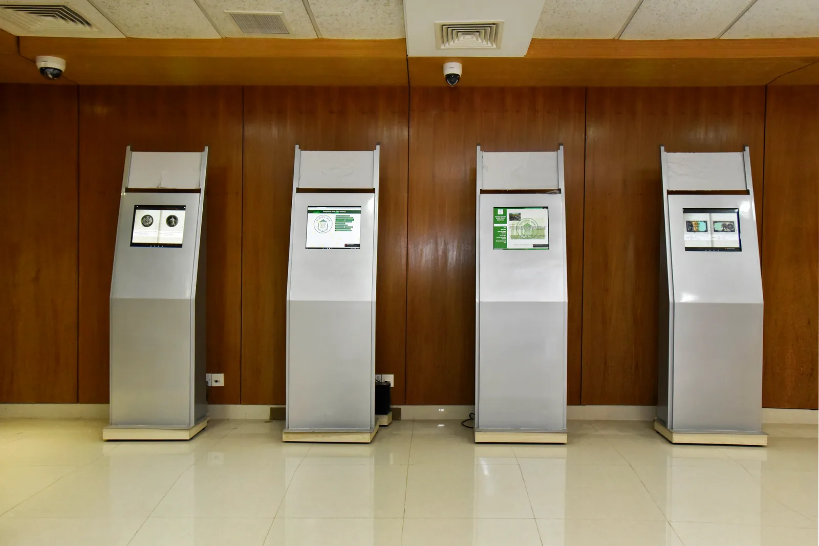 Two freestanding touchscreen information kiosks in a public setting