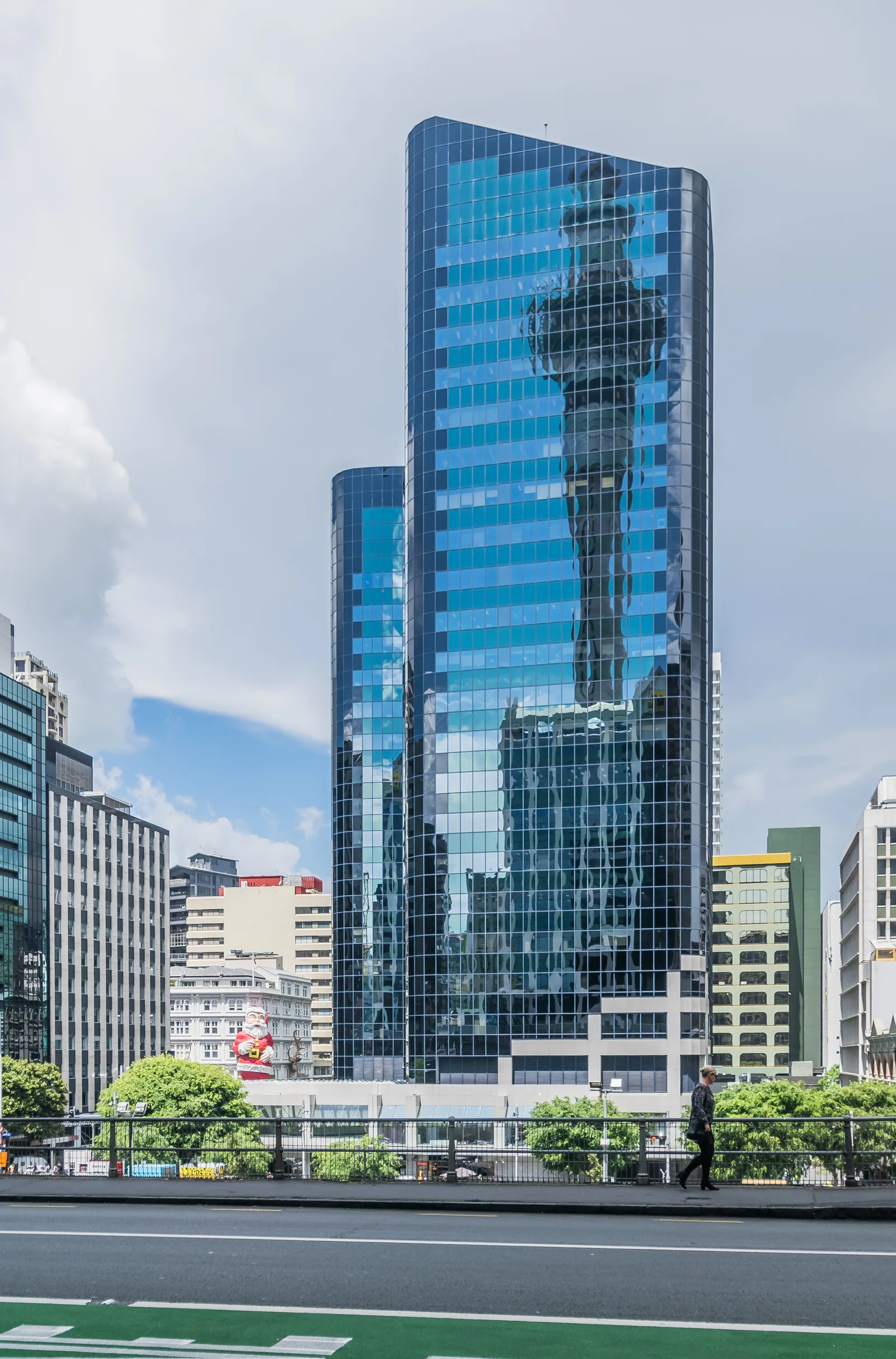 Reflective glass tower rising above a city street
