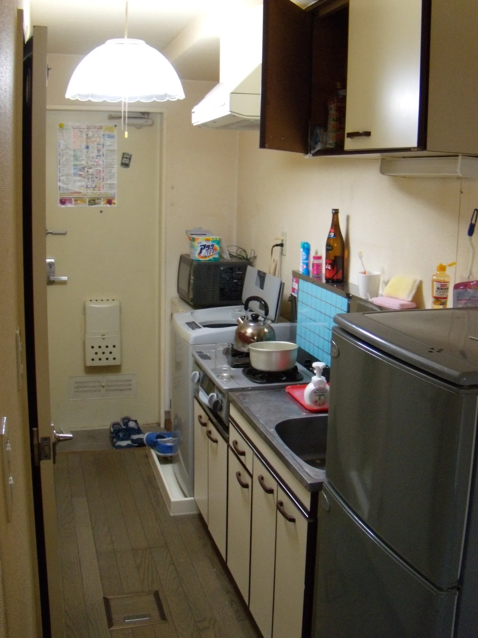 Finished apartment kitchen and living area viewed from the doorway
