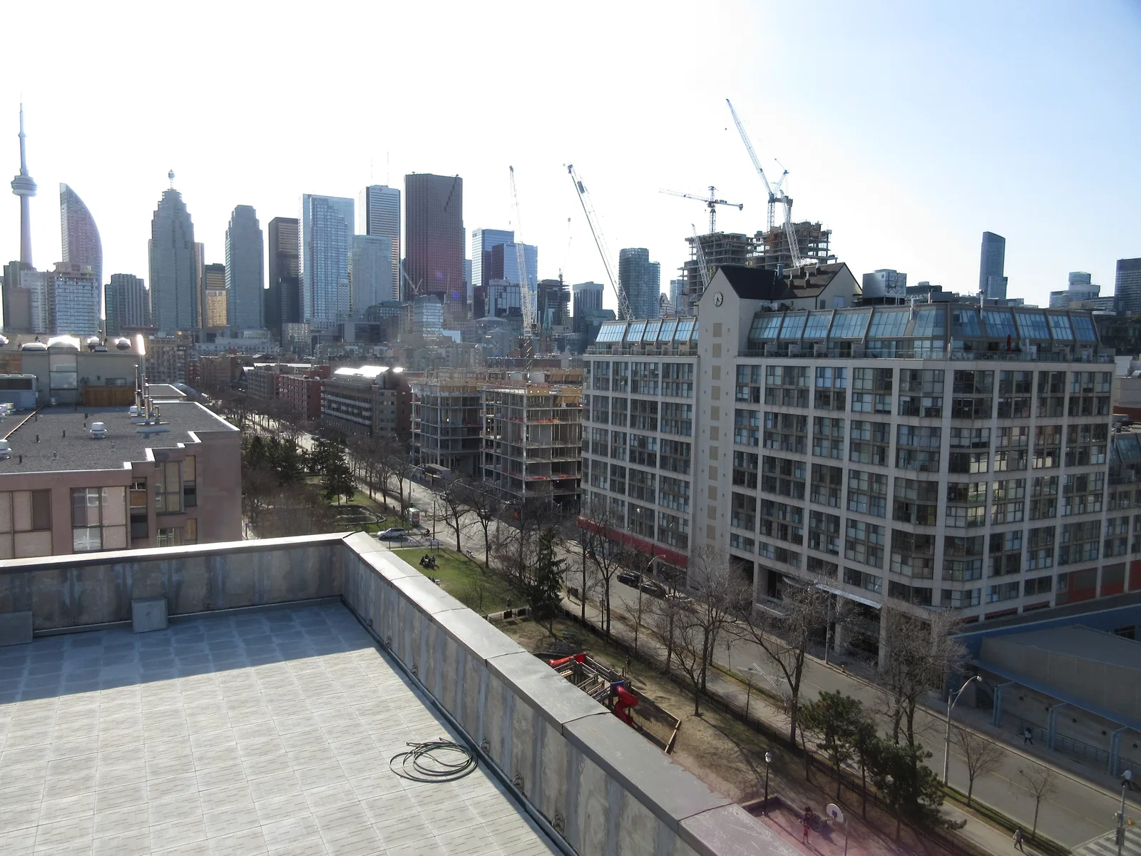City skyline with construction cranes above mid-rise buildings