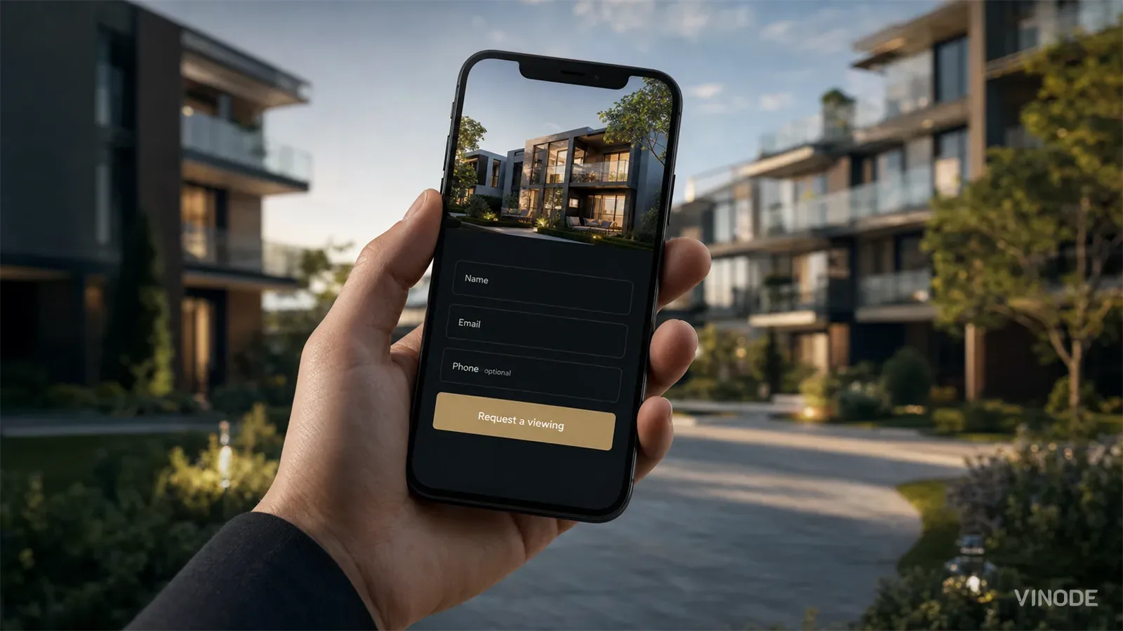 A real estate enquiry form on a smartphone held in a hand, showing name, email and an optional phone field with a 'Request a viewing' button, against a blurred residential 3D development.