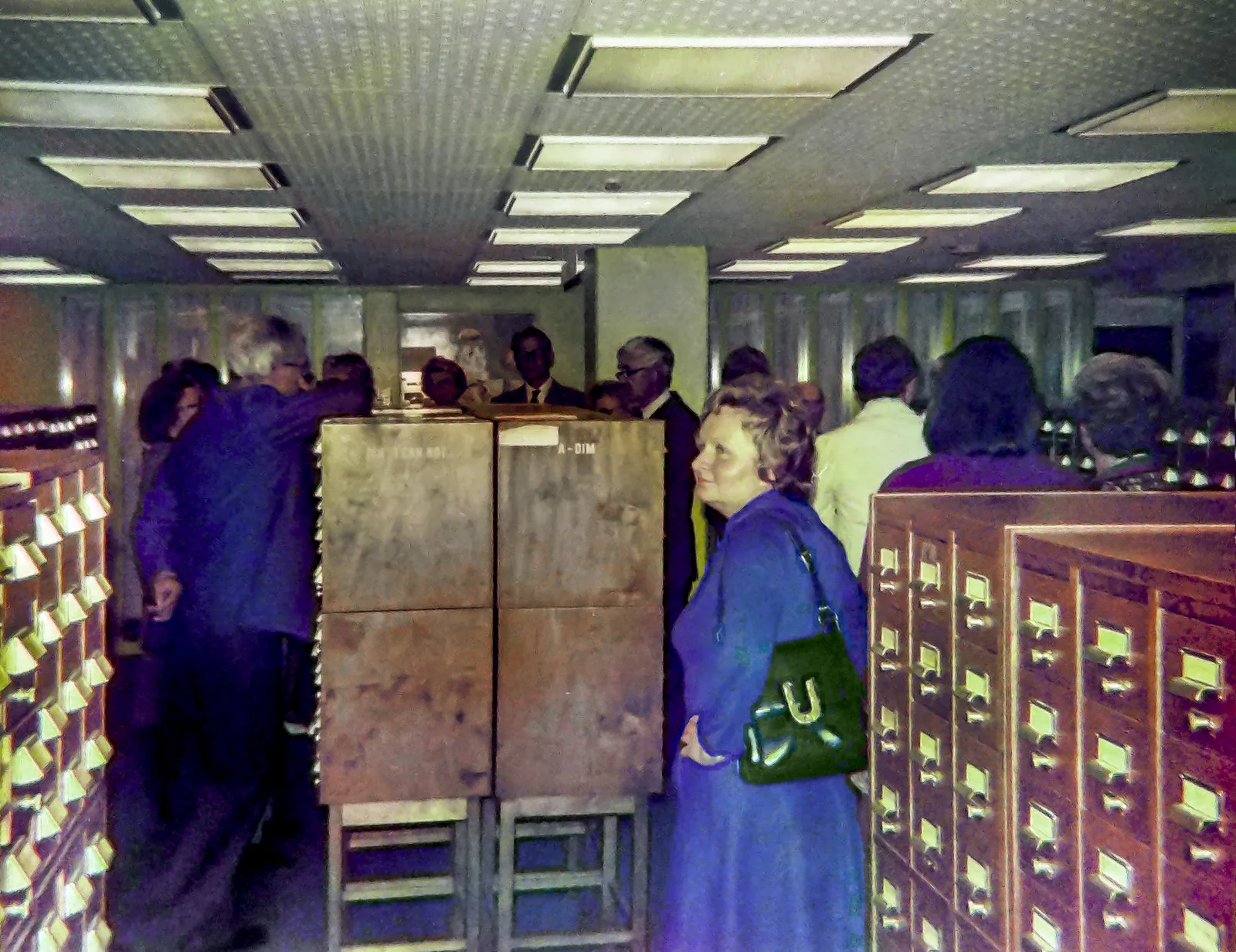 Crowded room with people standing among rows of card cabinets