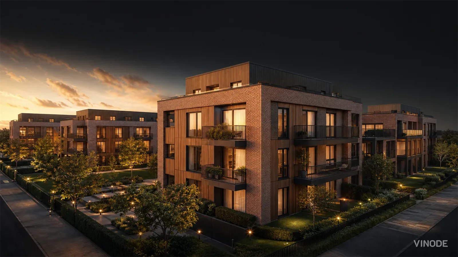 Sunset render of brick and metal-clad apartment buildings with landscaped grounds