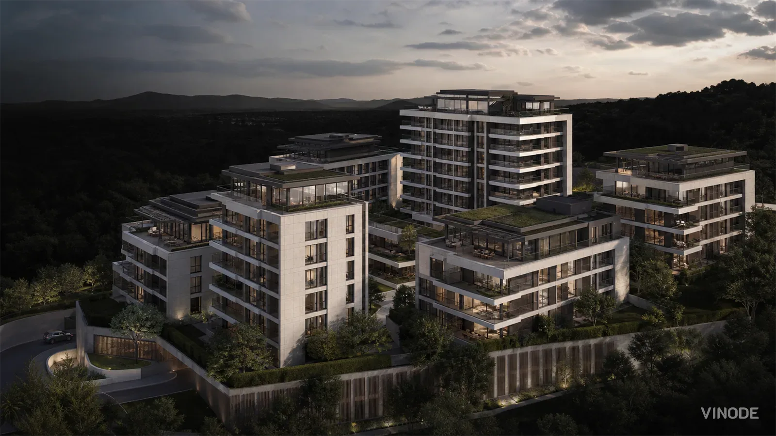 Aerial dusk render of white apartment buildings in a mountainous landscape